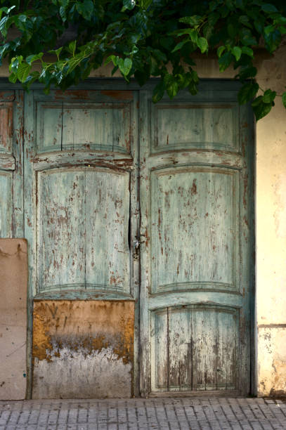 istock Door in green wood  with deteriorated paint 1162517471