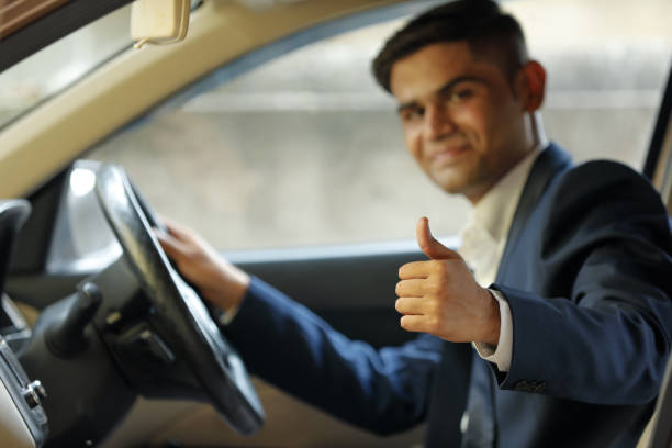 istock young indian man showing thumps up from car window 1162518064