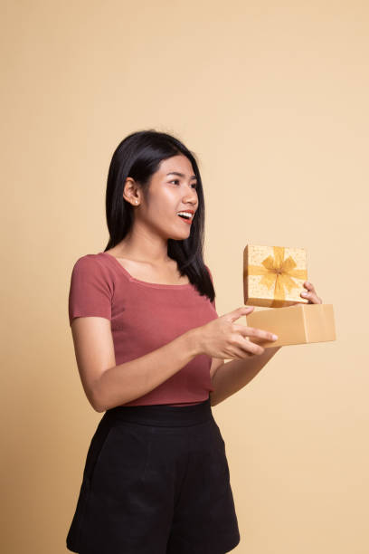 istock Young Asian woman open a gift box. 1162518124