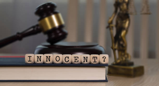 istock Word  INNOCENT composed of wooden dices. 1162518498