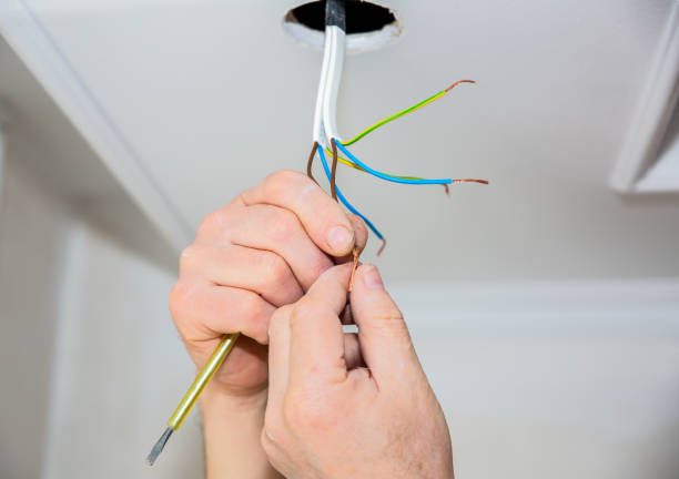 istock Man is making electrical insulator. Light bulb wires with adhesive tape. Maintenance repair works in the flat. Restoration indoors. 1162520058