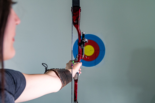 A young female Archer shooting arhery