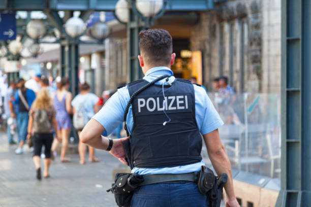 Hamburg, Germany - June 30 2019: Policeman in bulletproof vest patrolling outside of Hamburg Central Station.