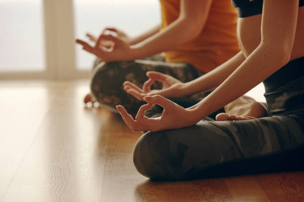 istock Yoga instryctor doing yoga with student in studio, 1162521681
