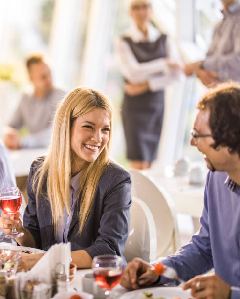 istock Happy business colleagues talking on a lunch break in cafeteria. 1162521803
