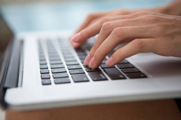 istock Female hands typing on keyboard laptop 1162523509