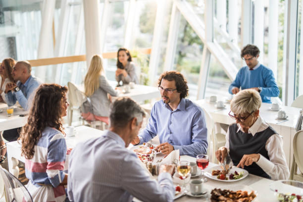 istock Large group of business people having lunch in cafeteria. 1162523593