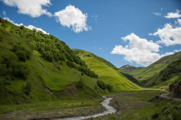 view of mountains and road to tusheti region at summer. georgia - tusheti imagens e fotografias de stock