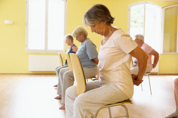 istock Yoga class: Senior women exercising on chair 1162524515