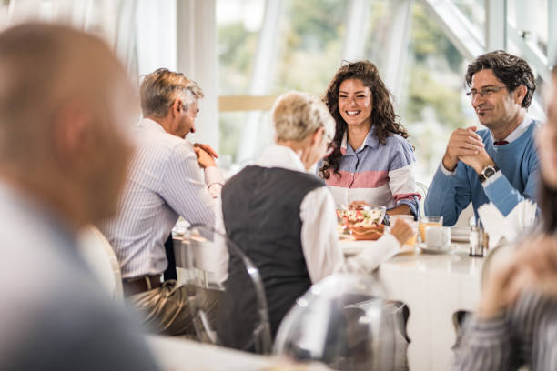 istock Happy business colleagues talking on a lunch break in cafeteria. 1162524719