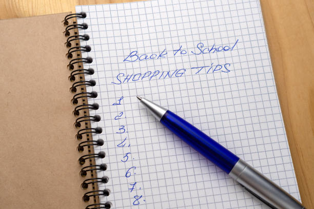 istock Blue pen on a notebook with sheets in a cage. Sign - back to school and shopping tips 1162524896