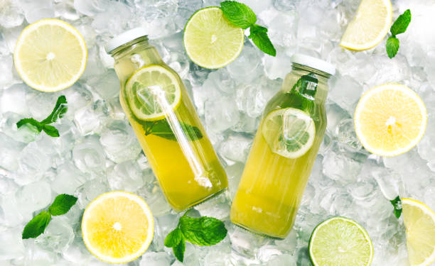 Fresh lemon cucamber detox water in glass jar on ice Healthy nutrition. Fresh lemon cucamber detox water in glass jar on ice background, panorama infused water stock pictures, royalty-free photos & images