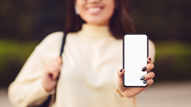 istock Woman holding and showing phone with blank screen 1162525863