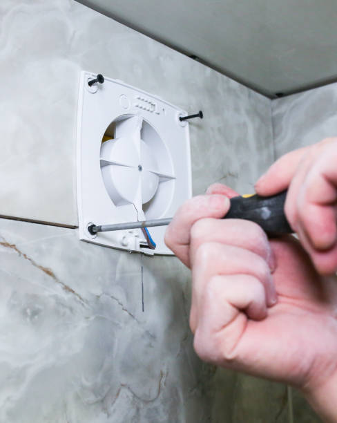 istock Man is making the wall bathroom fan vent. Restoration process. Screwdriver in hands. 1162525871