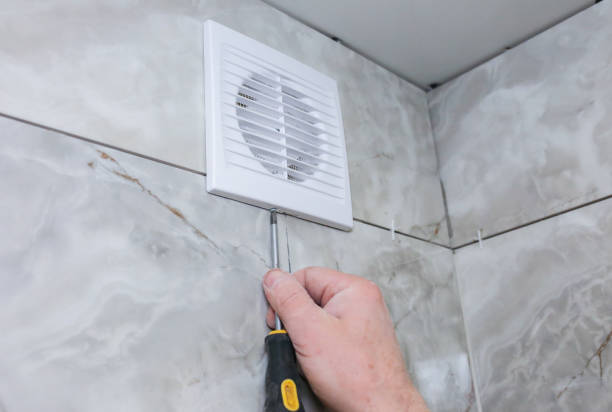 istock Man is making the wall bathroom fan vent. Restoration process. Screwdriver in hands. 1162525872