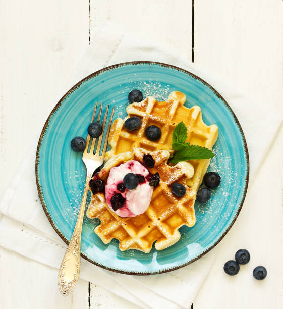istock Homemade waffles with a sprig of currants. White background. 1162525931