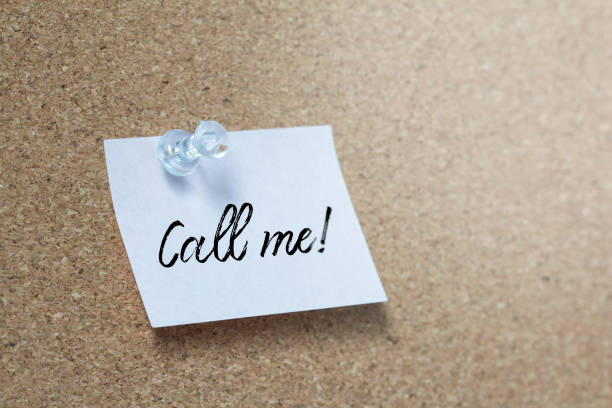 istock Call me handwriting note on a wooden corkboard 1162526012