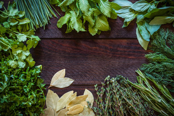 istock Various kinds of aromatic herbs frame on wooden table 1162526402