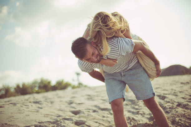 Lets go anywhere as long as it's together. Couple on sand.