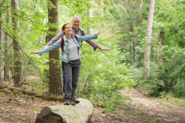 istock Hiking - senior couple walking through the forest 1162530678