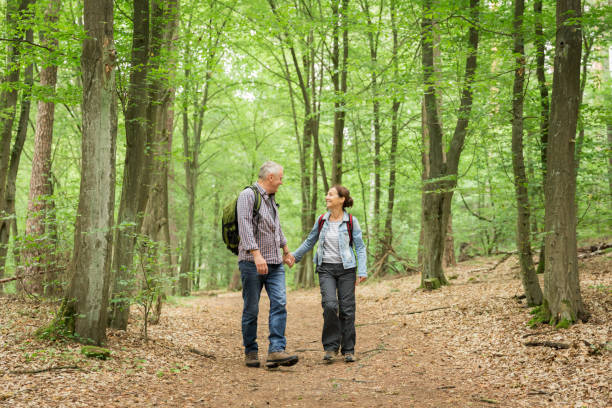 istock Hiking - senior couple walking through the forest 1162531123