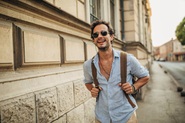 istock Charming man with backpack on the street 1162531223