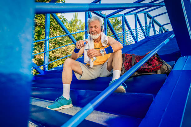 istock senior man taking refreshments and relaxing after workout 1162531345