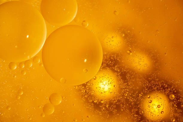 istock golden yellow bubble oil droplet, abstract background 1162532652