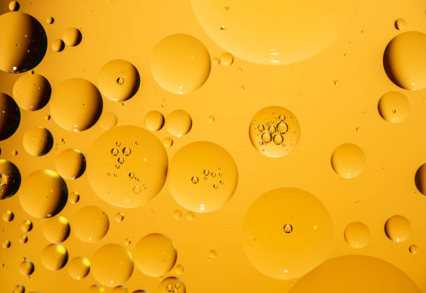 istock golden yellow bubble oil droplet, abstract background 1162532700