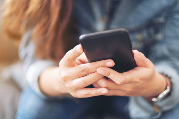 istock a beautiful asian woman holding , using and looking at smart phone 1162533117