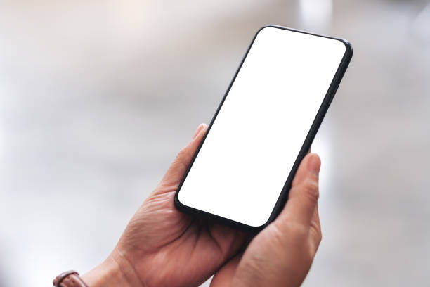 istock woman's hands holding black mobile phone with blank desktop screen 1162533120