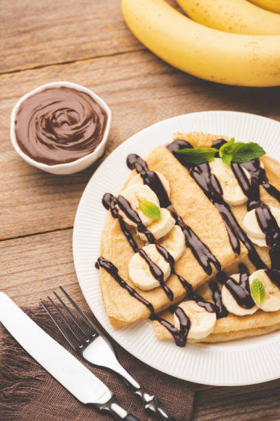 istock Crepe with bananas and chocolate on white plate 1162533230