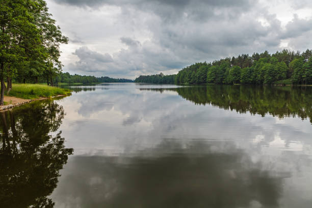 Reflection of moody sky in calm lake