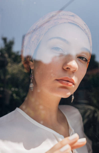 istock Beautiful woman by the window 1162536926