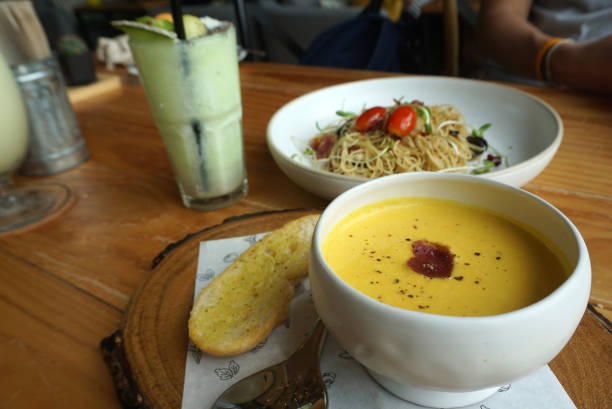istock yellow pumpkin soup with garlic bread serving on the timber block 1162537073