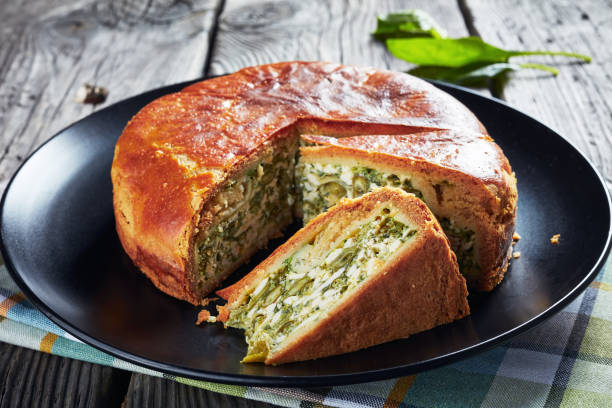 istock Green Bean spinach and blue cheese pie on a black plates with ingredients 1162538063