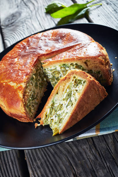 istock Green Bean spinach and blue cheese pie on a black plates with ingredients 1162538067