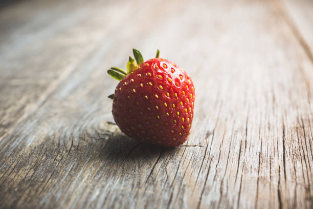 istock Ripe and juicy strawberries on the dark rustic background 1162538527