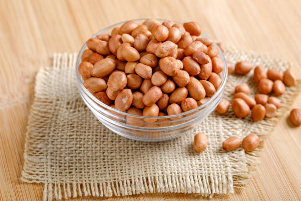 istock peanuts in bowl on the wooden background. 1162539882