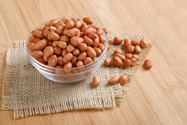 istock peanuts in bowl on the wooden background. 1162539884