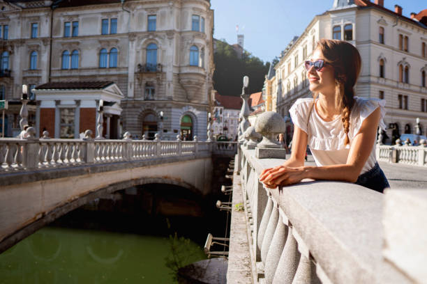 istock Young smiling woman standing by the Bridge 1162545745
