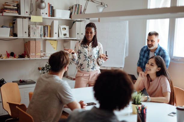 istock Female leader talking to her employees 1162546761
