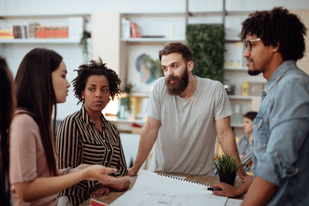istock Multiethnic Team of architects reviewing reports in the office 1162547172