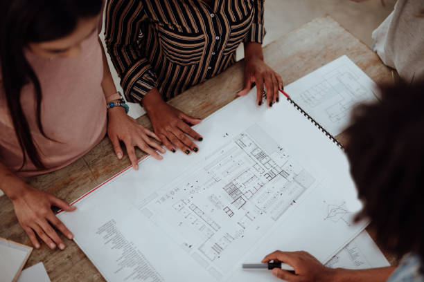 istock Multiethnic Team of architects reviewing reports in the office 1162547191