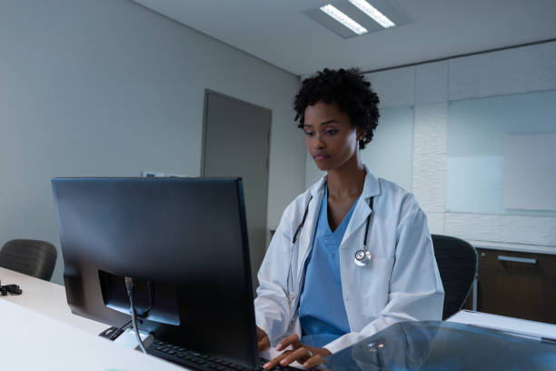 istock Female doctor working on computer at desk in hospital 1162547614