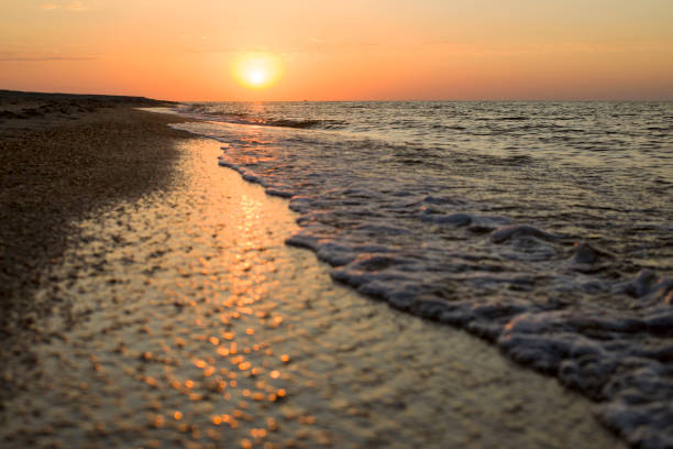 istock Sunrise over the deserted sea beach 1162550666