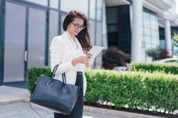 istock Attractive businesswoman browsing on her tablet 1162552652