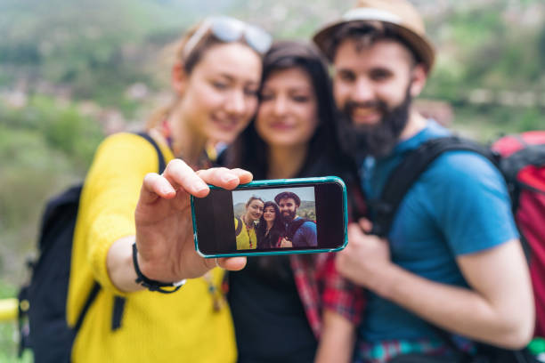 istock Cheerful friends making selfies while hiking in the mountains 1162552671