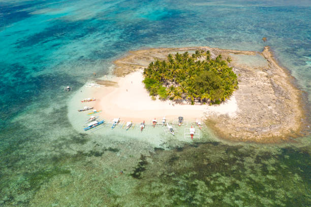 istock Guyam island, Siargao, Philippines. Small island with palm trees and a white sandy beach 1162552676