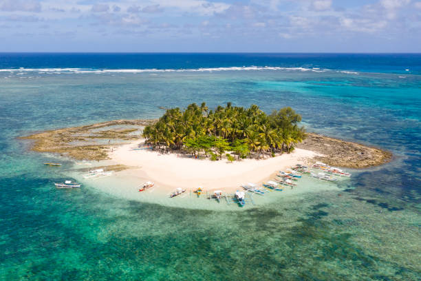 istock Guyam island, Siargao, Philippines. Small island with palm trees and a white sandy beach 1162552732